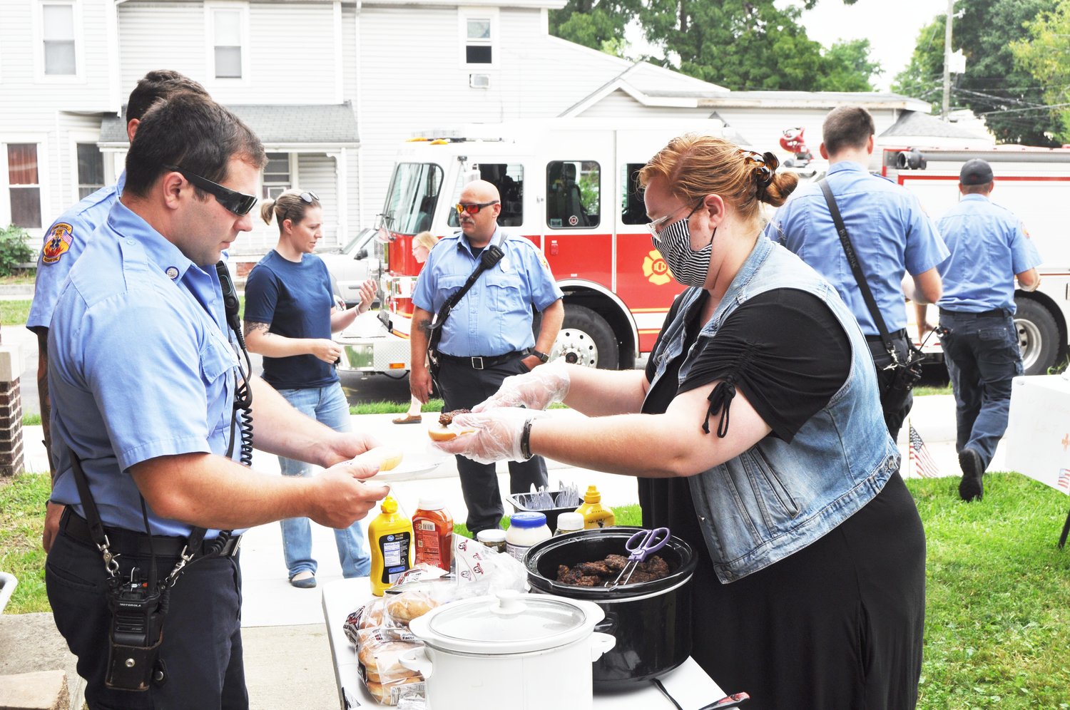 Praise Sharp serves a hamburger to Crawfordsville firefighter/EMT Cody Haslam Saturday at The Pentecostals of Crawfordsville. The church served free food to first responders and military personnel to recognize the 19th anniversary of the Sept. 11 attacks.